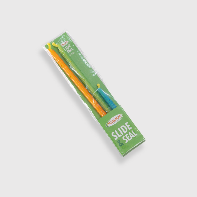 Colorful Slide & Seals plastic tools with orange, yellow, blue handles in green package