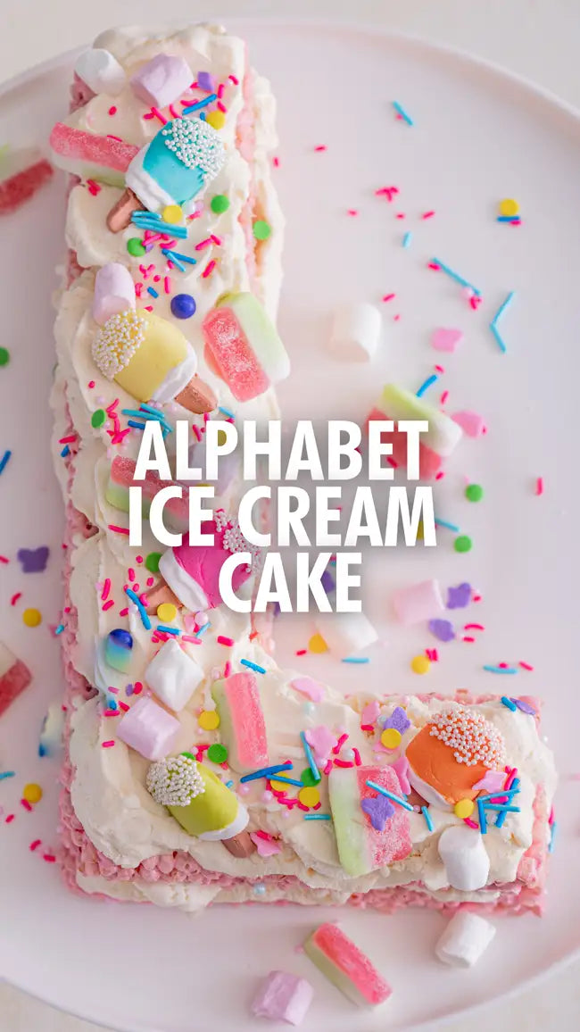 Alphabet ice cream cake with colorful sprinkles and candy decorations.