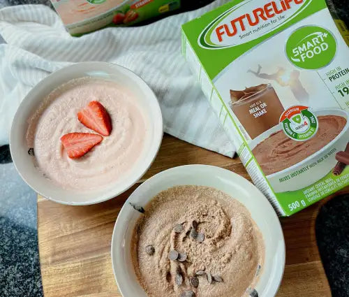 A box of futurelife smart food protein powder in chocolate flavor, featuring a green and white design with images of smoothies.