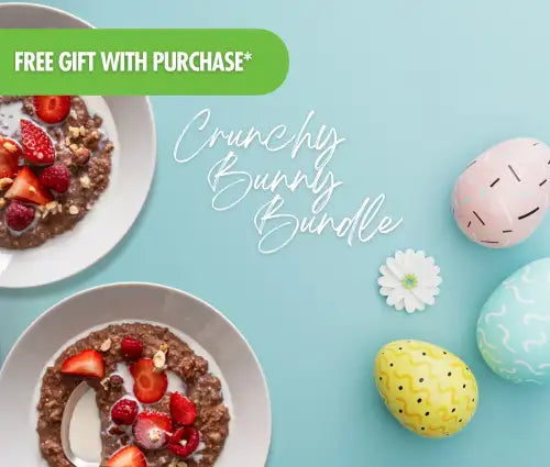 Crunchy bunny bundle oatmeal bowls topped with fresh berries and nuts, served in white ceramic dishes alongside decorative pastel easter eggs.