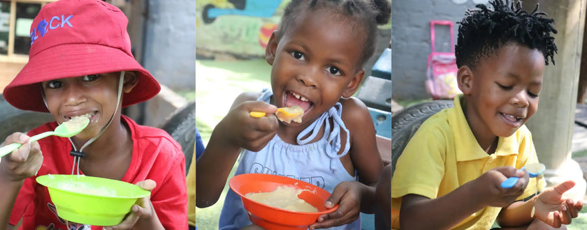 Green plastic bowl with red interior and white rim, likely made of recycled material.