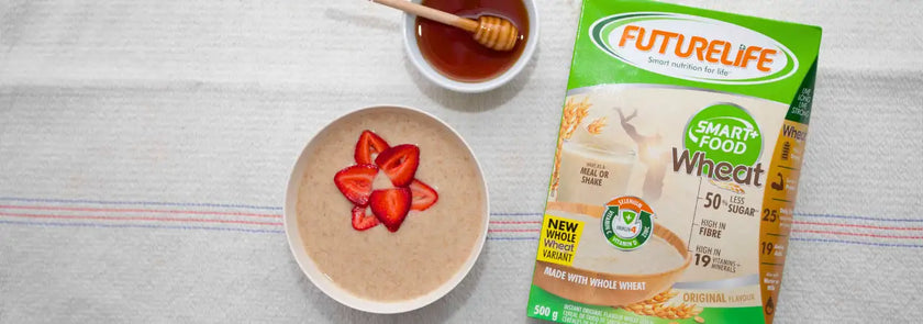 A green and white futurelife smart food wheat cereal box with a label indicating it’s made with whole wheat, 50% less sugar, and contains 25g of fiber per serving.