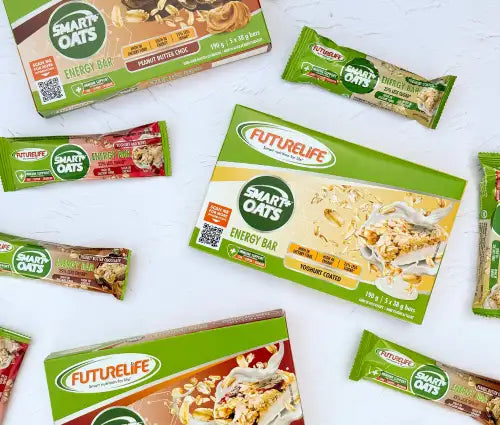 Green and white futurelife smart oats energy bar boxes with peanut butter chocolate flavor, surrounded by individual wrapped bars in matching packaging.