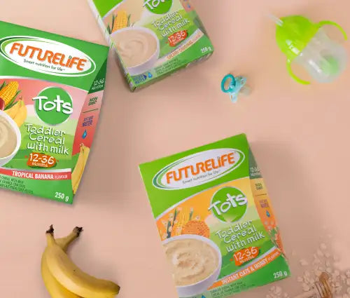 Green and white futurelife tots toddler cereal boxes with tropical banana flavor, featuring images of corn and bananas on the packaging.