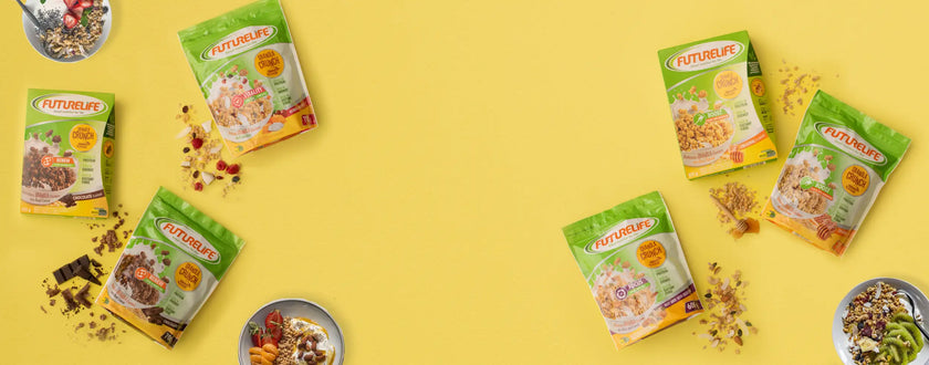 Green and white herbal tea bags with colorful herbs on yellow background.