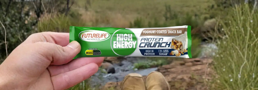 High-energy protein crunch bar with a green and white label, featuring nuts and seeds on the packaging.
