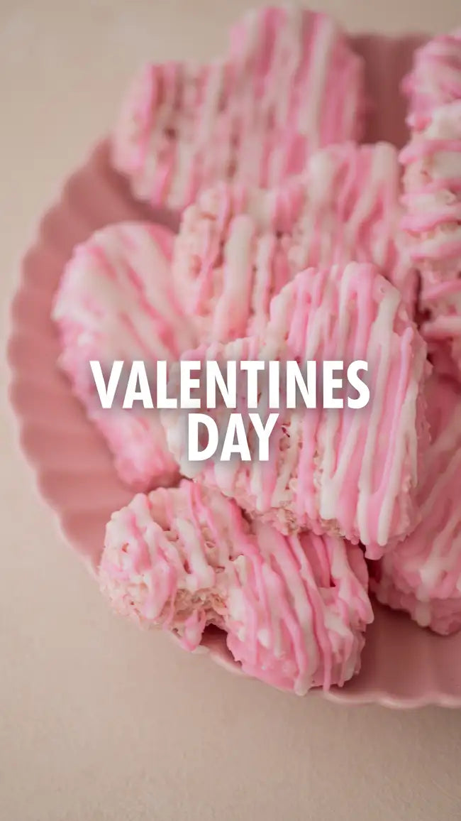 Pink and white striped candy cane-shaped treats on a scalloped plate.