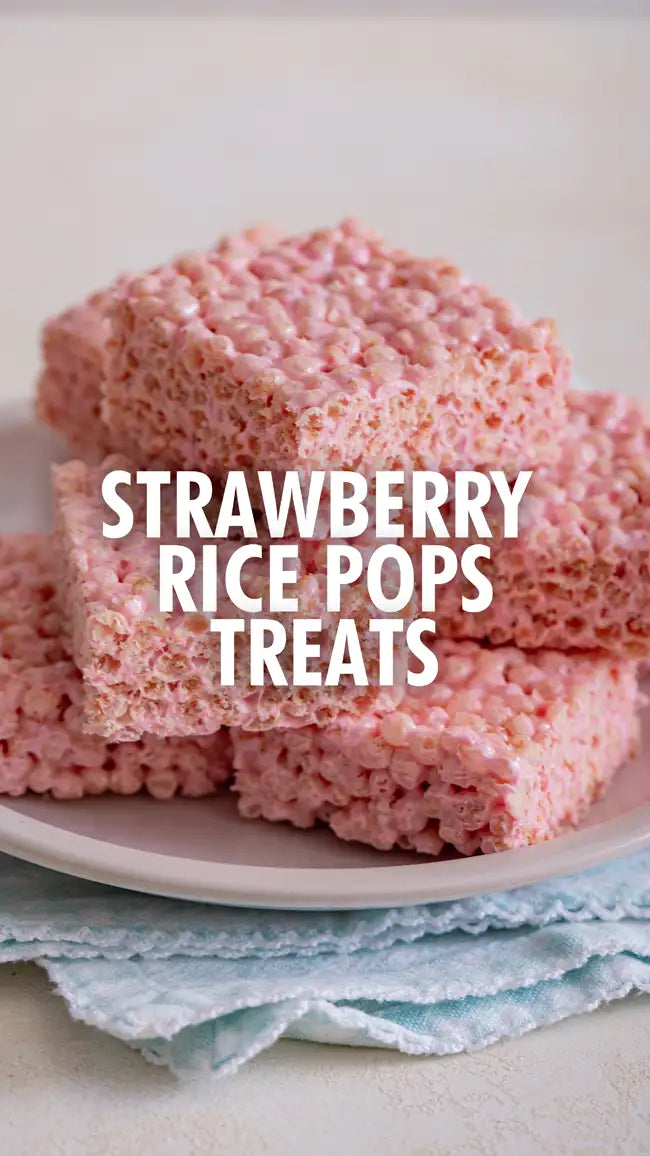 Strawberry rice pops treats pink square cereal bars with white text on a plate.