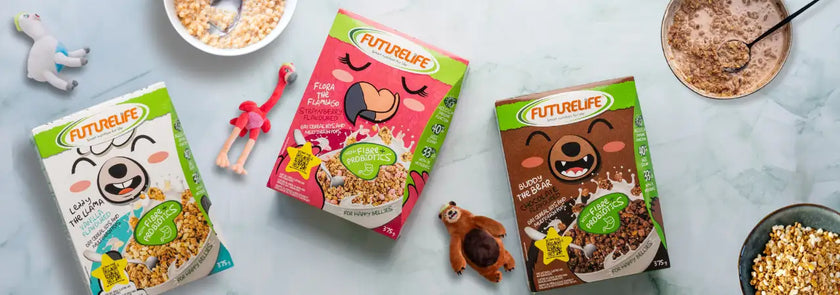 Three colorful futurelife cereal boxes, each featuring a cartoon bear face and different flavors like ’fruit & flavour’ in pink packaging or chocolate with nuts.