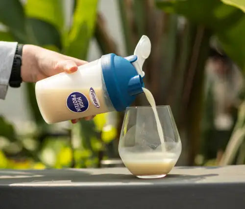 White and blue protein shaker bottle with a flip-top cap.