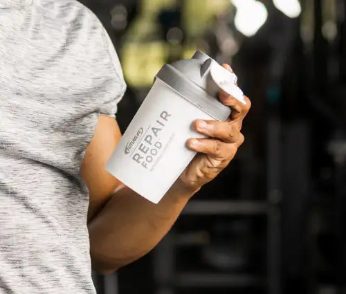 White and gray shaker bottle with ’repair food’ label.